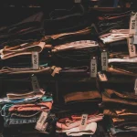 Neatly folded clothes with price tags on shelves in a Taipei shop.