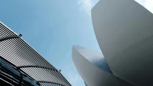 Dynamic view of sleek architectural designs reaching into a clear blue sky.